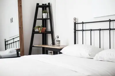 a bedroom with a bed and a table and a ladder at Coliving Trastevere in Rome