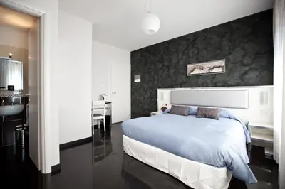 a bedroom with a large bed and a bathroom at Heart of Rome Rooms in Rome