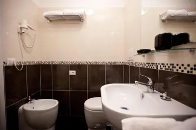 a bathroom with a sink and a toilet at Heart of Rome Rooms in Rome