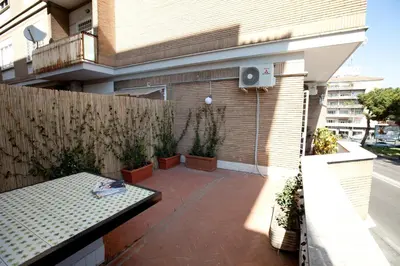 a patio with a fence and a table on a balcony at Heart of Rome Rooms in Rome