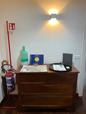 a wooden dresser with a lamp on top of it at Le Naiadi in Rome