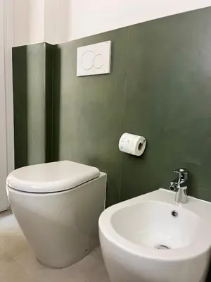 a bathroom with a white toilet and a sink at Le Naiadi in Rome