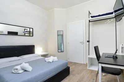 a bedroom with a bed and a desk and a computer at Comfort Rooms Piazza Mariano Armellini in Rome