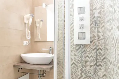a bathroom with a sink and a shower at Comfort Rooms Piazza Mariano Armellini in Rome