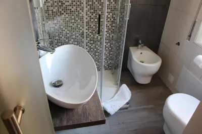 a bathroom with a sink and a toilet and a shower at Comfort Rooms Piazza Mariano Armellini in Rome