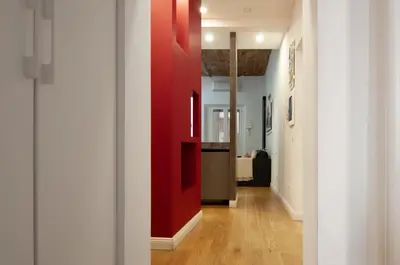 a hallway with a red wall in a house at Urbanflat Repubblica Square in Rome