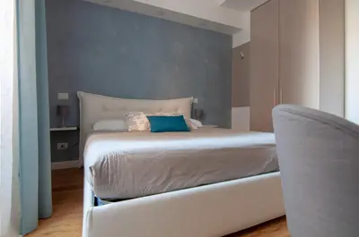 a bedroom with a bed and a chair in it at Urbanflat Repubblica Square in Rome