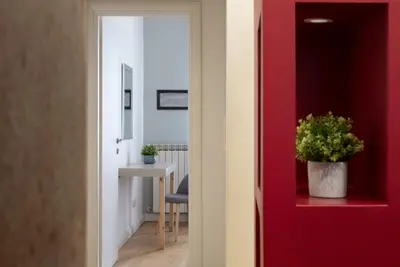 a red door with a potted plant in a room at Urbanflat Repubblica Square in Rome