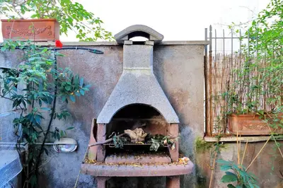 an outdoor pizza oven with a bird inside of it at THE ROMAN NEST ai Musei Vaticani in Rome
