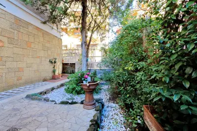 a garden with a vase with flowers in it at THE ROMAN NEST ai Musei Vaticani in Rome