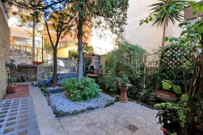 a garden with flowers and plants in a building at THE ROMAN NEST ai Musei Vaticani in Rome