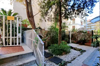 a garden with a fence and a tree at THE ROMAN NEST ai Musei Vaticani in Rome