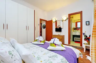 a bedroom with a bed with towels on it at THE ROMAN NEST ai Musei Vaticani in Rome