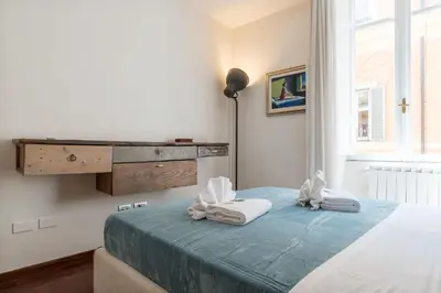 a bedroom with a bed with towels on it at CS Spanish Steps Apartment in Rome