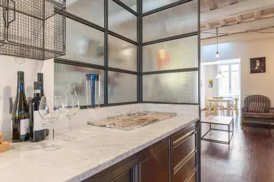a kitchen with a counter with two wine glasses at CS Spanish Steps Apartment in Rome