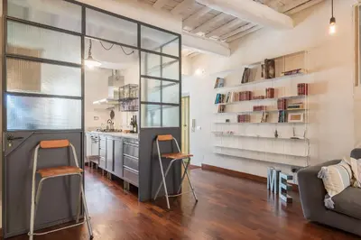 a kitchen with sliding glass doors and a living room at CS Spanish Steps Apartment in Rome