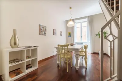 a kitchen and dining room with a table and chairs at CS Spanish Steps Apartment in Rome