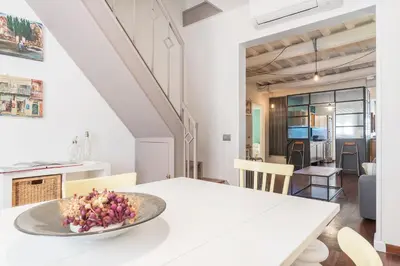 a white table with a bowl of flowers on it at CS Spanish Steps Apartment in Rome