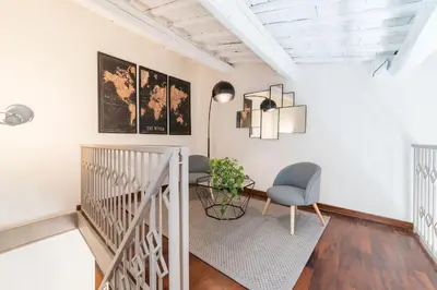 a hallway with a chair and a table in a room at CS Spanish Steps Apartment in Rome