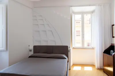 a bedroom with a bed in front of a window at Rome in Rome in Rome