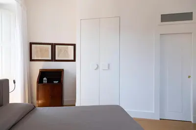 a bedroom with white cabinets and a bed at Rome in Rome in Rome