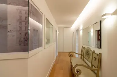 a hallway with a bench and pictures on the wall at Rome in Rome in Rome