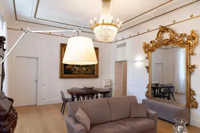 a living room with a couch and a mirror at Rome in Rome in Rome
