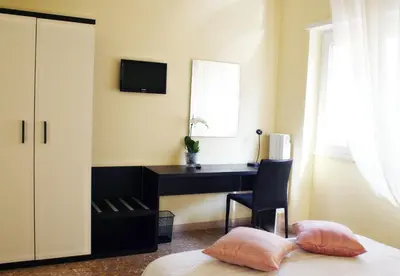 a bedroom with a desk and a bed with two pillows at Eco B&B Marela in Rome