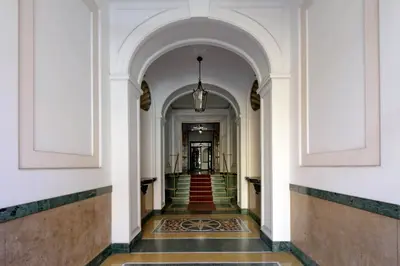 a hallway of a building with a staircase at BQ House Colosseo Luxury Rooms in Rome