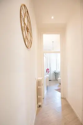 a hallway with a large clock on the wall at Rome Sweet Home near Metro Flaminio in Rome