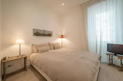 a bedroom with a large bed and a television at Rome Sweet Home near Metro Flaminio in Rome