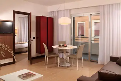 a living room with a table and chairs at Residence Hotel Parioli in Rome