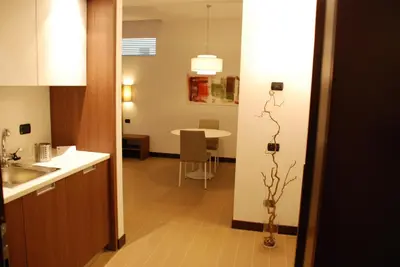 a kitchen with a table and a vase with a plant at Residence Hotel Parioli in Rome