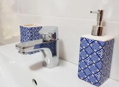 a bathroom sink with a blue and white tile dispenser at Il Giardino Al Pigneto in Rome