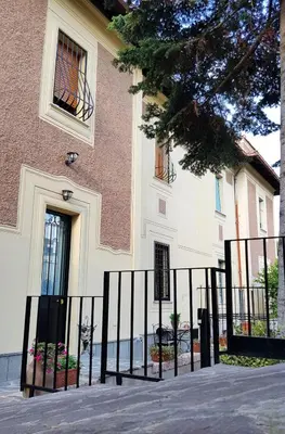 a building with a fence in front of it at Il Giardino Al Pigneto in Rome