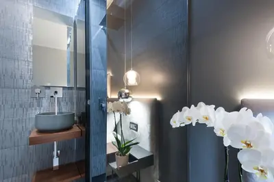 a bathroom with a blue sink and a mirror at LuMa Suite Via Veneto - Your luxury style 22 in Rome