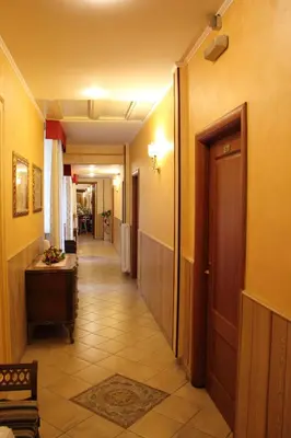 a corridor of a hallway with a door and a hallwayngth at Hotel Giugiù in Rome