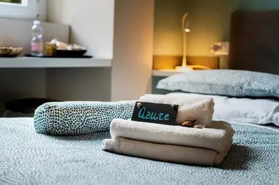 a pile of towels sitting on top of a bed at Paola Guest House in Rome