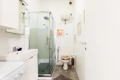 a bathroom with a toilet and a glass shower at Pop House in Rome