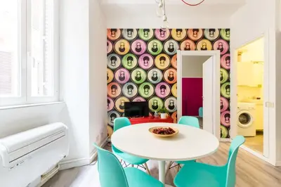 a dining room with a white table and blue chairs at Pop House in Rome