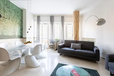 a living room with a couch and a table at ROMAC San Saba 5-Bedroom and Terrace near Ostiense in Rome