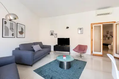 a living room with a couch and a table at ROMAC San Saba 5-Bedroom and Terrace near Ostiense in Rome