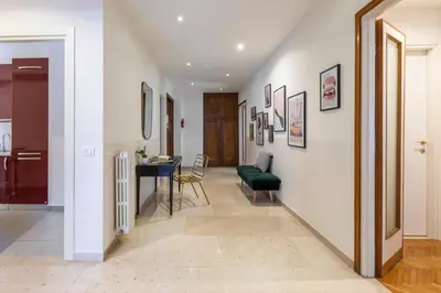 a hallway with a living room and a dining room at ROMAC San Saba 5-Bedroom and Terrace near Ostiense in Rome