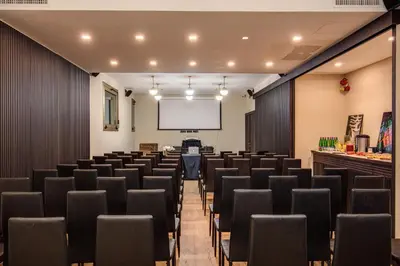 a conference room with chairs and a projection screen at Prassede Palace Hotel in Rome
