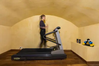 a person running on a treadmill in a room at ROMAC Coronari with gym, sauna and garden in Rome