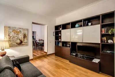 a living room with a couch and a table at Holiday Apartment Bernini Near The Trevi Fountain - 4 Bedroom in Rome
