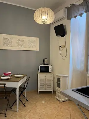 a small kitchen with a table and a microwave at Old Bakery Rome Suites & Apartments in Rome