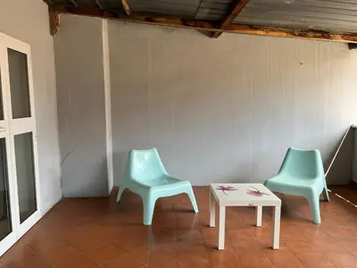 two green chairs and a table in a room at Old Bakery Rome Suites & Apartments in Rome