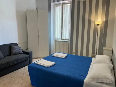 a living room with a blue bed and a couch at Old Bakery Rome Suites & Apartments in Rome