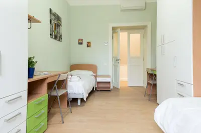 a bedroom with a desk and a bed and a desk at Beautiful apartment in San Giovanni close to Colosseo in Rome